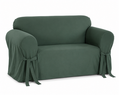 hunter green loveseat covered with a fitted slipcover on a white background