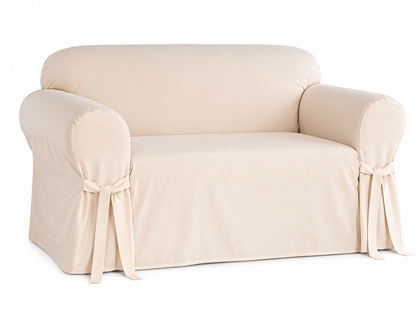 natural colored loveseat covered with a fitted slipcover on a white background